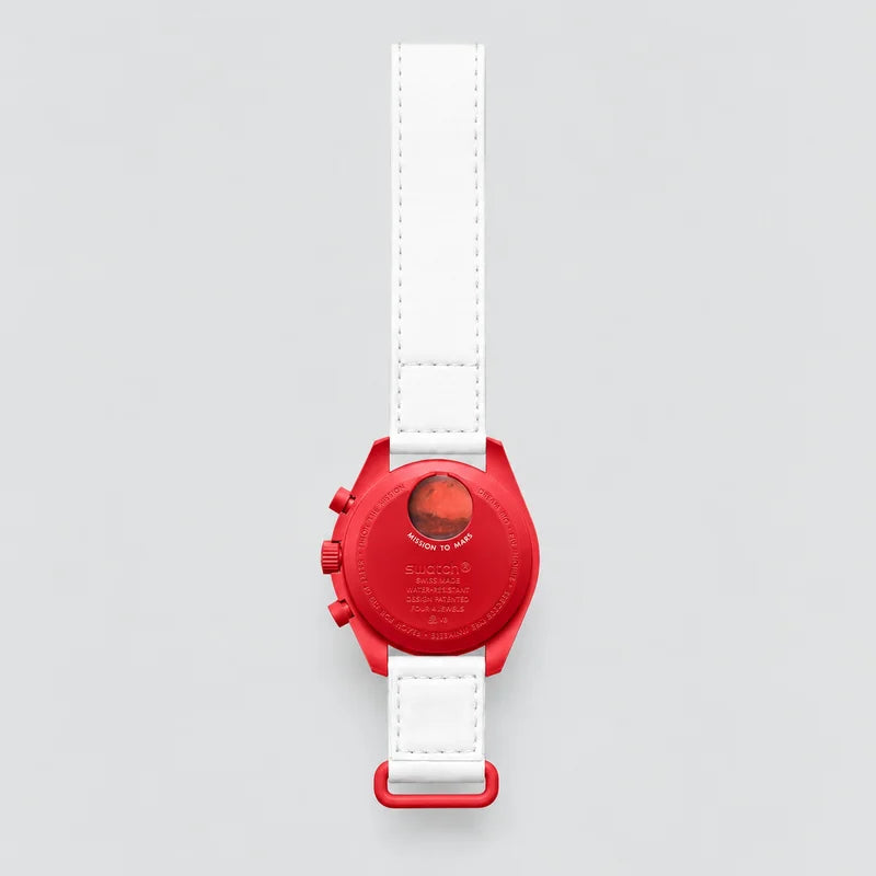 Mission to Mars, back view of the watch with its strap: red case with a white dial and a white strap.